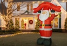 10-foot Santa in front of a chirstmas lit house