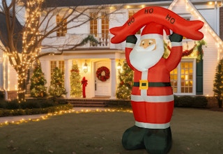 10-foot Santa in front of a chirstmas lit house