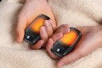 Person holding the Kesguar Hand Warmers Rechargeable 2 Pack in their hands.