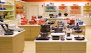Le Creuset products on shelves in outlet store