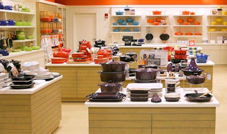 Le Creuset products on shelves in outlet store
