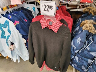 black sweater over a red plaid shirt