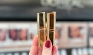 hand holding two l'oreal paris colour riche lipsticks