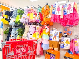 kids' halloween costumes sitting on a target shelf
