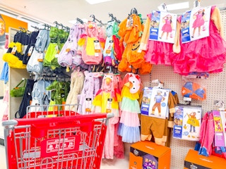 kids' halloween costumes sitting on a target shelf