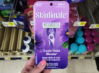 hand holding a pack of skintimate disposable razors at dollar general