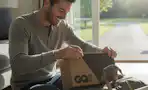 a man opening a gq box