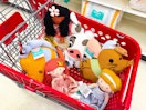 disney plush pillow buddies sitting in a target cart