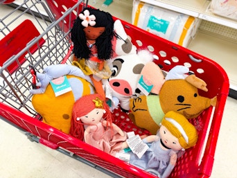 disney plush pillow buddies sitting in a target cart