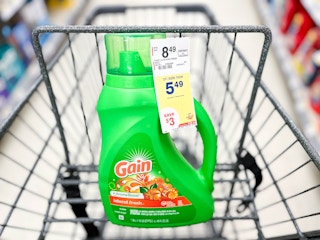 one bottle of Gain laundry detergent in shopping cart with sales tag attached to bottle