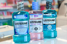 three bottles of Listerine mouthwash on a store counter