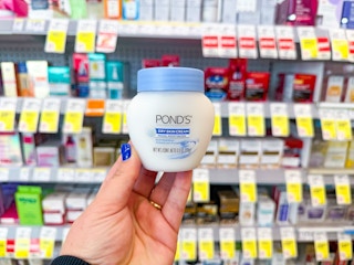 hand holding pond's moisturizer in walgreens