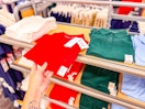 hand grabbing cat & jack kids' school uniform shirt off a target shelf