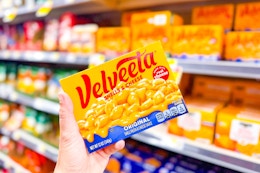 hand holding a box of velveeta shells & cheese