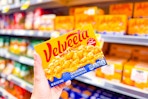 hand holding a box of velveeta shells & cheese