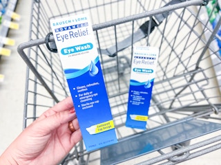  hand holding a box of Bausch + Lomb Eye Relief eye wash