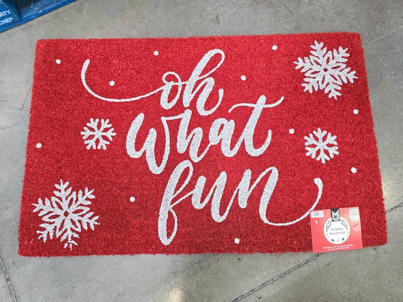 red doormat that says "oh what fun" with snowflakes