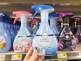 hand holding a bottle of febreze fabric refresher spray at dollar general