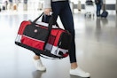 a woman holding a swissgear duffel bag