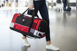 a woman holding a swissgear duffel bag
