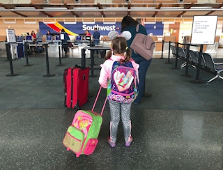 young girl with Jojo Siwa bag in Southwest airport check-in