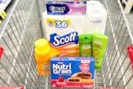 crest toothpaste, scott toilet paper, garnier shampoo, arm & hammer detergent, and nutrigrain bars in a cart
