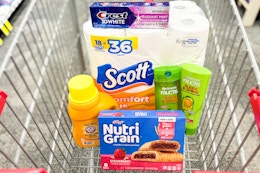 crest toothpaste, scott toilet paper, garnier shampoo, arm & hammer detergent, and nutrigrain bars in a cart