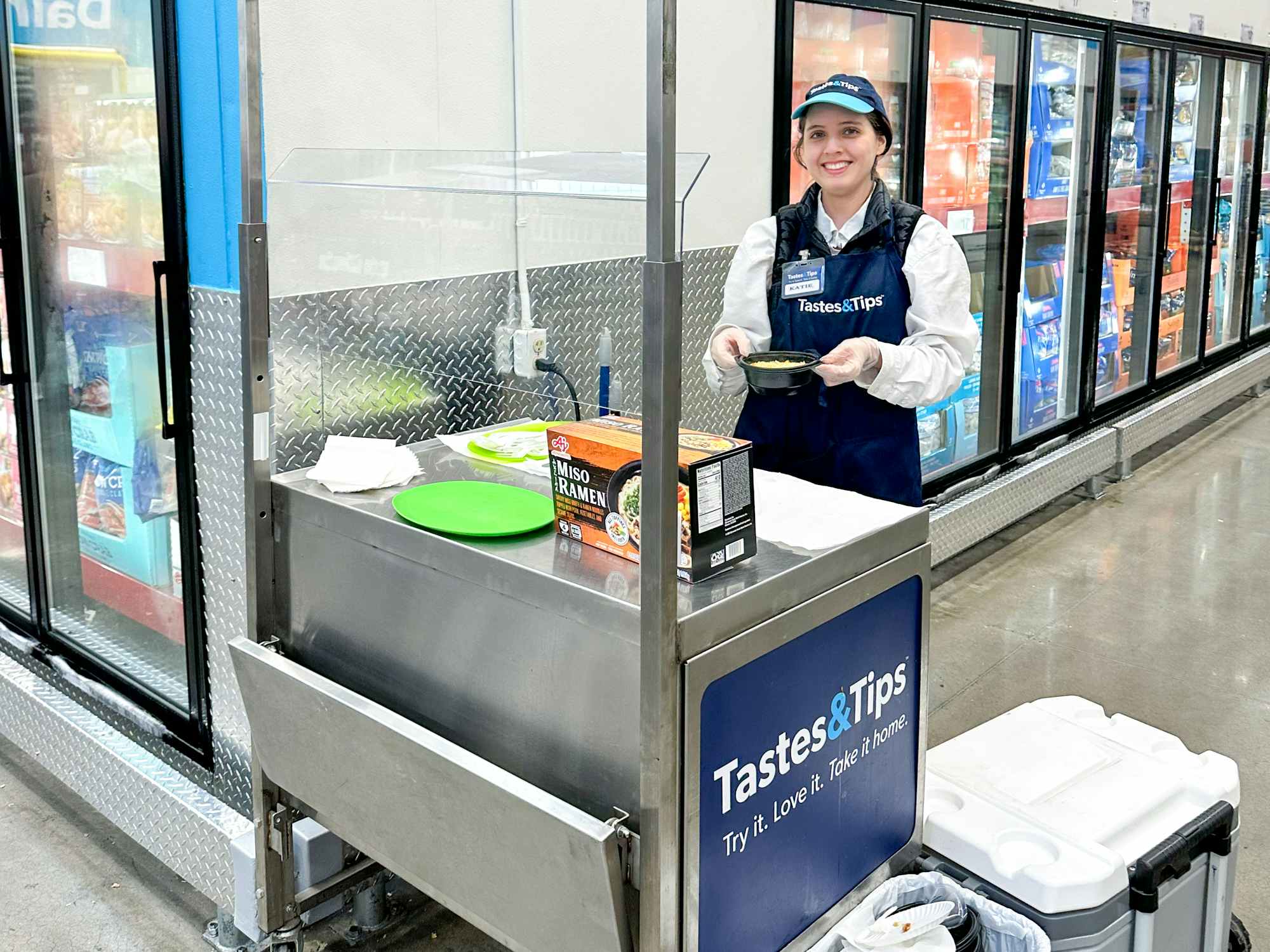a Sam's Club employee working at a free sample booth inside the store