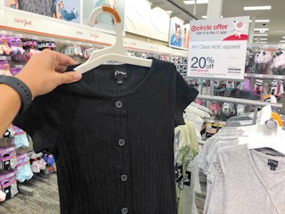 hand holding a art class dress at target