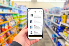 hand holding a smartphone displaying 1-clip coupons in the cvs app
