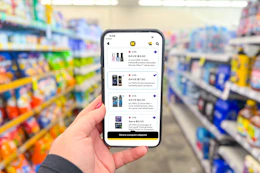 hand holding a smartphone displaying 1-clip coupons in the cvs app