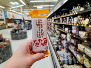 hand holding perfect bar at walmart