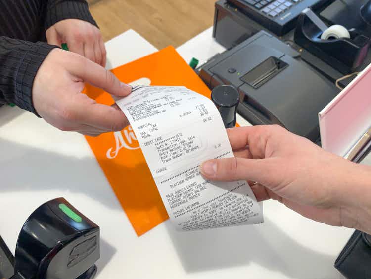 Employee and shopper exchanging an Ulta receipt