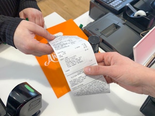 Employee and shopper exchanging an Ulta receipt