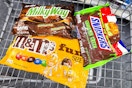 m&m's, milky way, and snickers candy bags in a cart