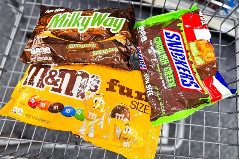 m&m's, milky way, and snickers candy bags in a cart