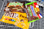 m&m's, milky way, and snickers candy bags in a cart