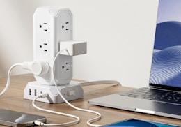 a tower power strip on a desk with a computer