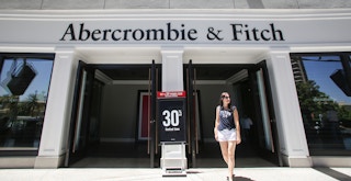 A person walking out of an Abercrombie & Fitch store