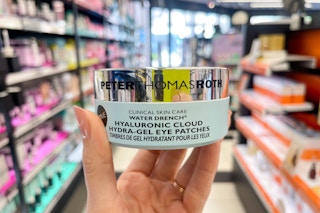 hand holding jar of eye patches in store aisle