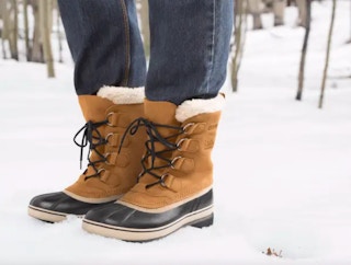 a person wearing sorel boots in the snow