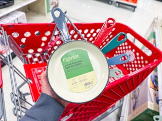 hand holding a figmint cast iron skillet over a target cart