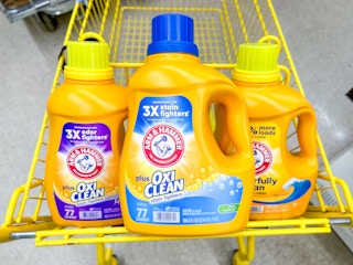 Arm & Hammer laundry detergent in a yellow Dollar General cart