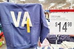 person holding up a state of mine sweatshirt