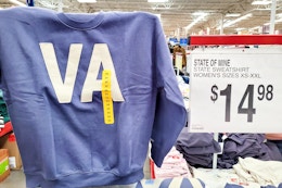 person holding up a state of mine sweatshirt
