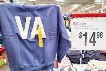 person holding up a state of mine sweatshirt
