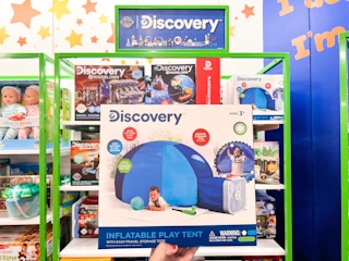someone holding a discovery kids dome tent