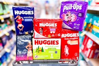 huggies diapers, pull ups, goodnites, and wipes stacked in a walgreens shopping cart