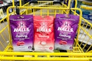 3 halls cough drops in a yellow dollar general shopping cart