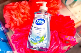 bottle of dial hand soap on red loofahs